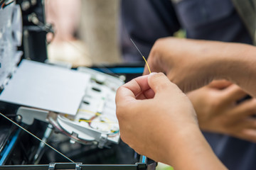 Technicians are install cabinet on fiber optic cable.