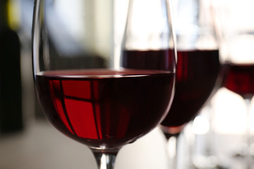 Glass of red wine on table in restaurant, closeup