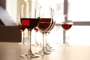 Glasses with red and white wine on table in restaurant