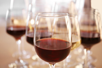 Glasses with red and white wine on table in restaurant