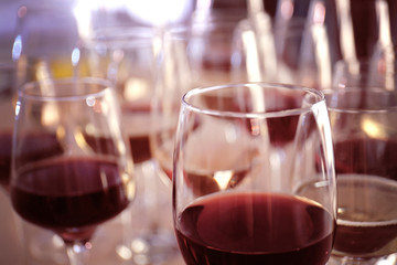 Glasses with red and white wine on table in restaurant