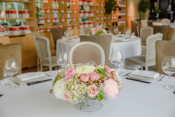 Little bouquet of chrysanthemums and roses stands in the middle