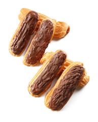 Delicious eclairs with chocolate in a row on white background