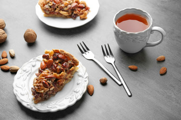 Cup of tea and tasty tart on table