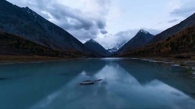 Time Lapes. Belukha Mountain and Highland Lake Akkem in autumn before sunrise. Altay Mountains, Russia.