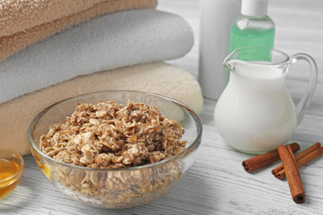 Body scrub, honey and cosmetics on wooden background