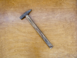 Hammer on wood background