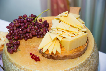 Fresh berries and sliced cheese on the table