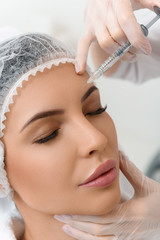 Professional beautician stops skin aging