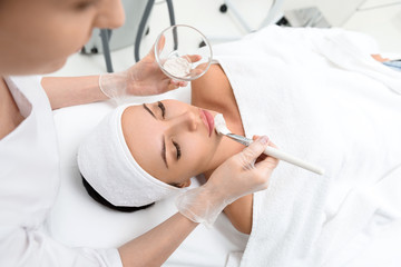 Professional beautician making facial treatment