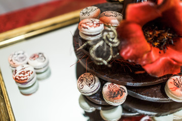 White macaroons lie on the old-fashioned mirror tray