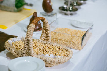 Yellow corns lie in a small basket on the table