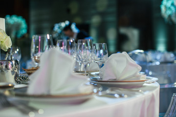 Sparkling glassware stands on the festive served dinner table
