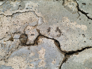 cracked and grainy rough concrete surface