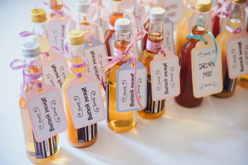 Bottles with yellow drinks and lettering 'Drink me' stand on the