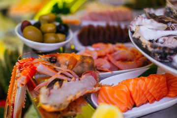 Squid and shrimp lie behind the plates with salted fish