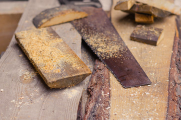 saw with sawdust and pieces of wood.