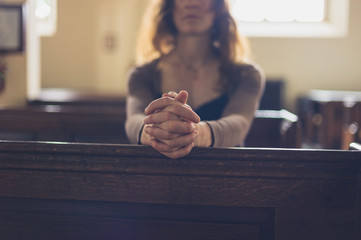 Young woman praying in church