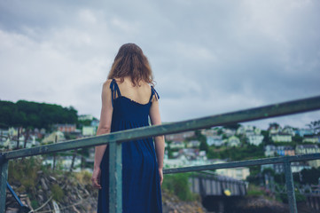 Young woman standing on steel bridge