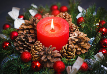 Decorated Christmas wreath with a candle close-up