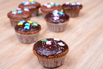chocolate muffins on wooden ground