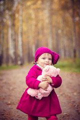 Little girl in autumn park