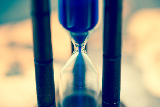 Close up of hourglass against grunge world map