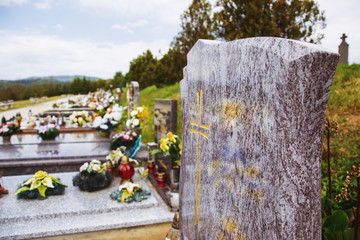 Close up of empty tombstone. Graves, tomb stones and crucifixes on traditional public cemetery....