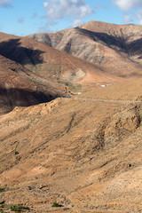 Beautiful volcanic mountains and the road on a mountain slope.  Road from la Pared to Betancuria . Fuerteventura. Canary Islands