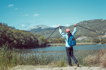 Outdoor shot of attractive young woman with backpack standing in