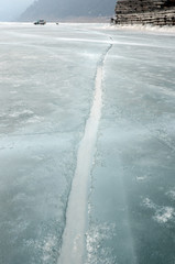 Small crack in the ice of Lake Baikal, filled with water