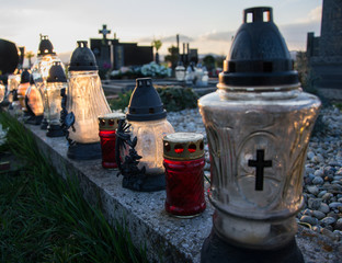 Votive candles lantern on the grave in Slovak cemetery. All Saints' Day. Solemnity of All Saints. All Hallows eve. 1st November. Feast of All Saints. Hallowmas. All Souls' Day
