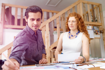 Two young architects in office