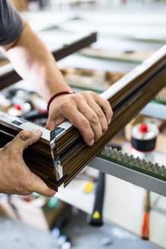 Manual worker assembling PVC doors and windows. Manufacturing jobs. Factory for aluminum and PVC windows and doors production. Selective focus. 