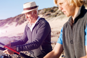 Senior man fishing with his grandson