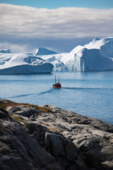 A boat in the icefjord of Ilulissat, Greenland © PASSENGER X