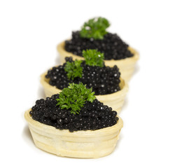 waffle basket with black  caviar  isolated on white