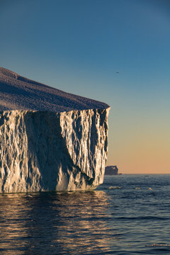 The sunset with icebergs on the ocean in Ilulissat, Greenland