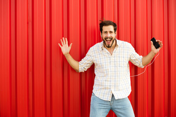 excited man smiling to camera on red background