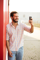 attractive man chating on his cellphone outside