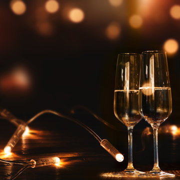 Champagne glasses in front of a festive background