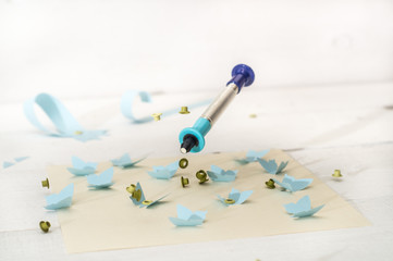 Fototapeta na wymiar tool to insert eyelets and blue butterfly