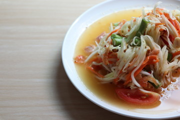 Papaya salad, Som Tam Thai very delicious and spicy in the white plate 