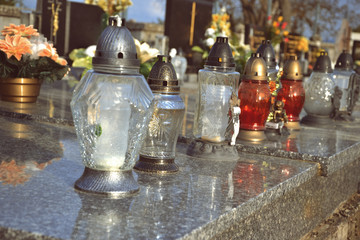 Votive candles lantern on the grave in Slovak cemetery. All Saints' Day. Solemnity of All Saints. All Hallows eve. 1st November. Feast of All Saints. Hallowmas. All Souls' Day