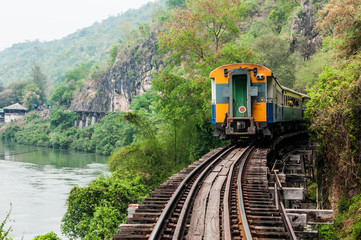 trains running on death railways track crossing kwai river in kanchanaburi thailand this railways...
