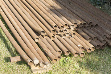 Rusty metal pipes stack on the construction site.