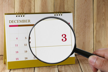Magnifying glass in hand on calendar you can look third date of