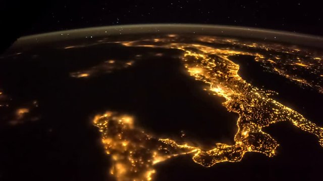 Earth and Italy from ISS. Elements of this video furnished by NASA. Italy lit night lights
