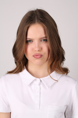 Obraz premium Seious teen in T-shirt. Close up. White background