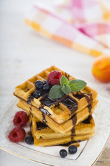 Delicious waffle with berries and chocolate